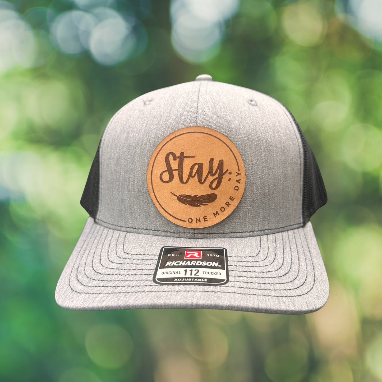 Richardson FlexFit mental health hat in charcoal with Stay One More Day leather patch — side view