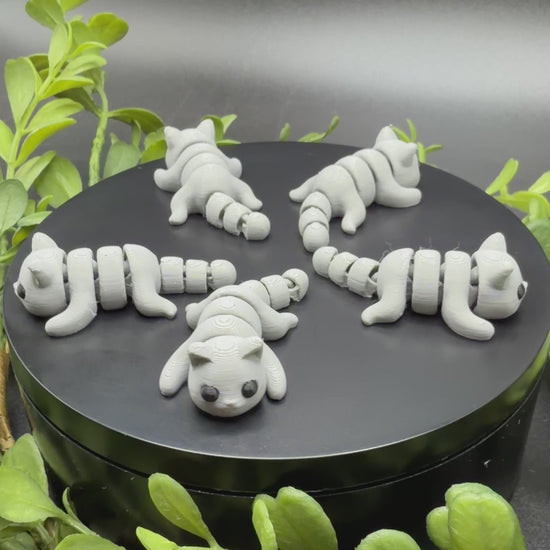 mini cat fidget toy in hand showing size and movement