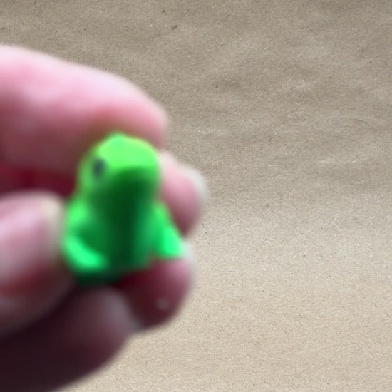 Three angles of 3D printed articulated iguana fidget toy — front, side, and rear views